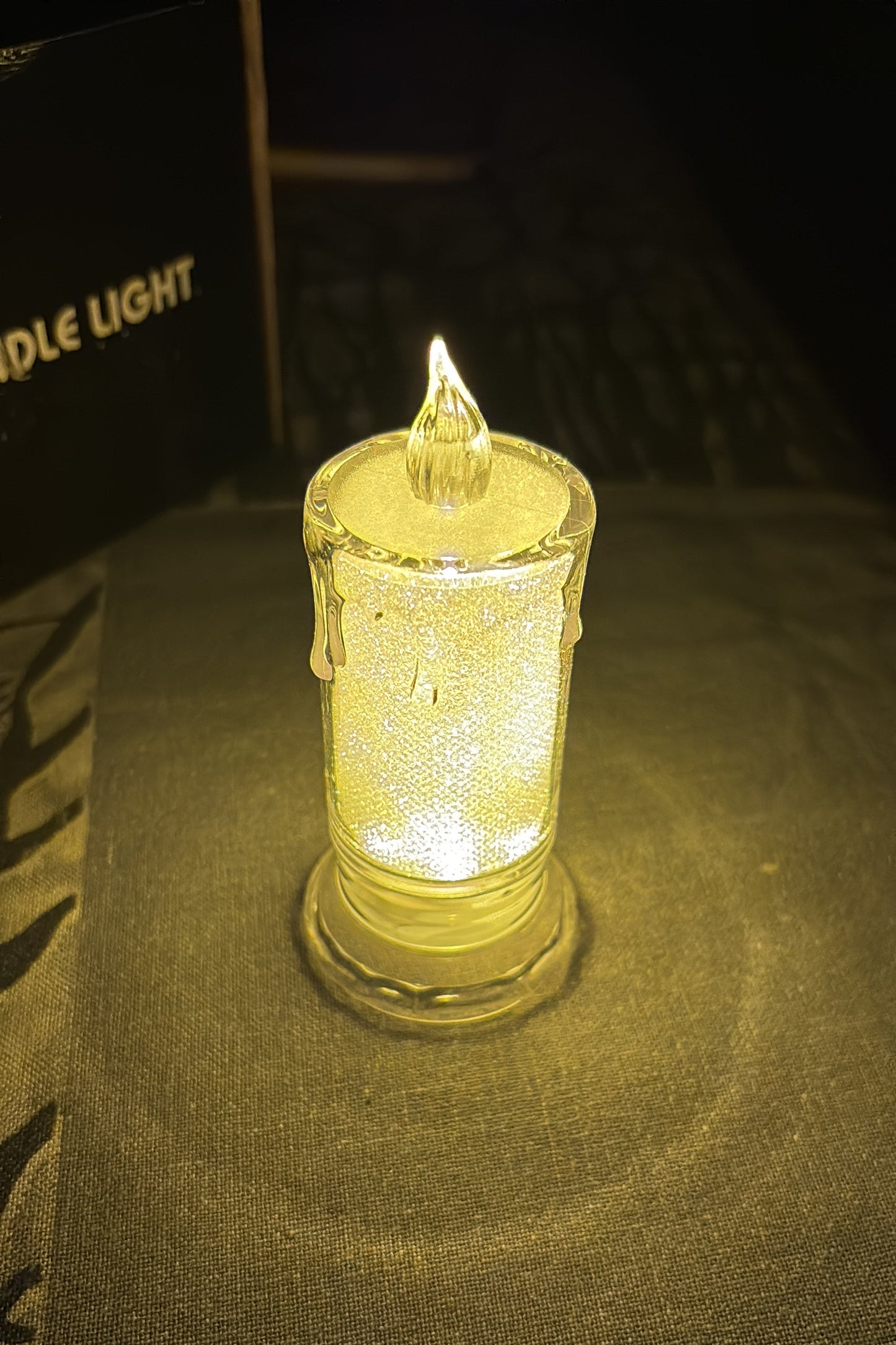 Glass lighter with a glowing yellow interior on a dark background