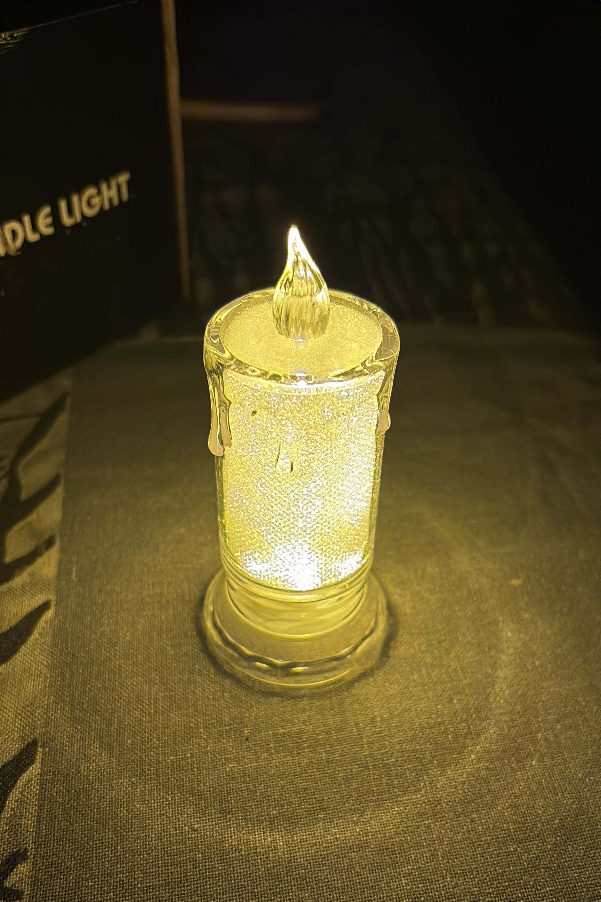 Glass lighter with a glowing yellow interior on a dark background